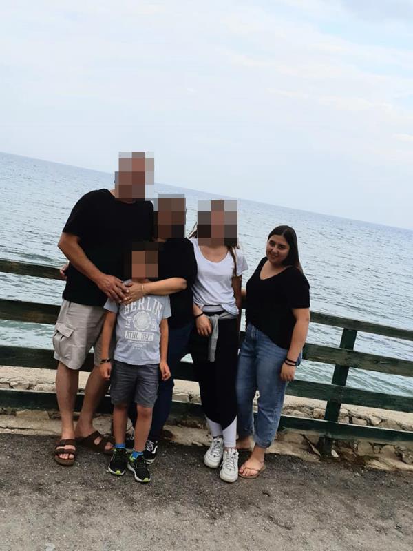 Eshel (right) stands with her family.