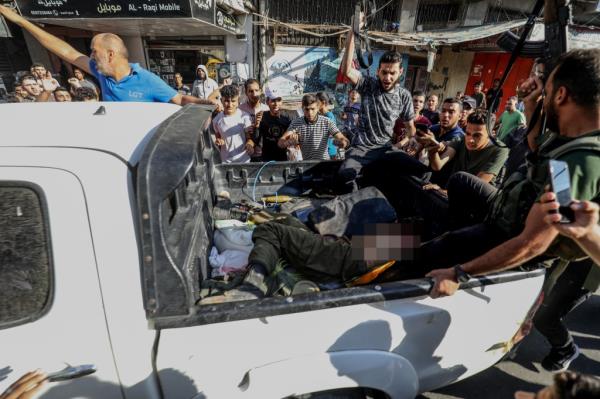 Palestinian militants surround a truck reportedly carrying a captured Israeli after crossing the border fence with Israel from Khan Yunis.