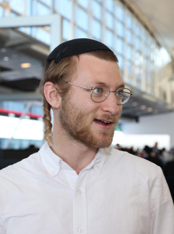 Noah Nierenberg in a white button down shirt at JFK airport