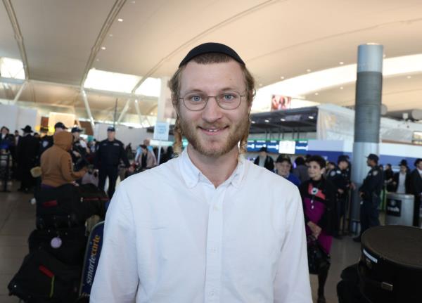Noah Nierenberg in a white button down shirt at JFK airport
